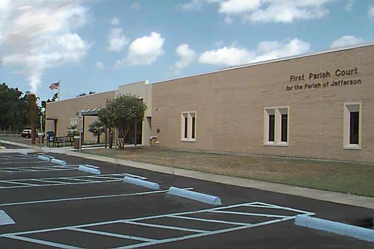 This is a Photo of First Parish Court for the Parish of Jefferson. First Parish Court handles Traffic and Misdemeanor Violations and Civil Disputes (up to $10,000).  It is located at the corner of West Metairie and David Drive. The two Judges are elected.  Traffic Court is often handled by local attorneys who are appointed as Judges "Ad Hoc".  The Court maintains long hours because of Night Court. There is no snack bar but there are a few vending machines. (The addition of a Coffee Shop would be a wonderful thing!) Parking is free.  